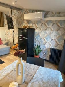 a kitchen with a table with a vase of flowers on it at Siente Muralla in Lugo