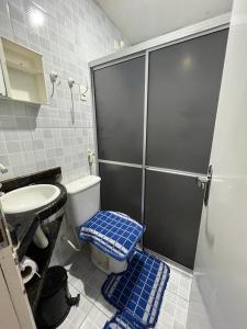 a bathroom with a shower and a toilet and a sink at Chalé em Tamandaré in Tamandaré