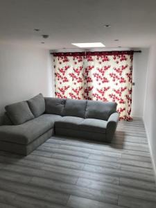 a living room with a gray couch in a room at 30A Mortlake in London
