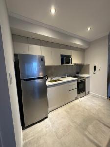 a kitchen with a stainless steel refrigerator and appliances at Departamento en Santa Fe Capital, sobre calle Boulevard Pellegrini in Santa Fe