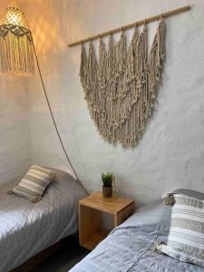 a bedroom with two beds and a table and a lamp at Departamento nuevo a estrenar! in Manzanillo +28 photos