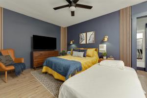 a bedroom with a bed and a flat screen tv at Chic Oasis Studio: Minutes to Downtown & Beaches in National City