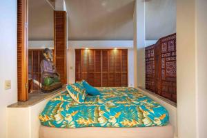 a bedroom with a large bed in a room at Jasmine Suite on Lush farm in Haiku, Maui jungle in Huelo