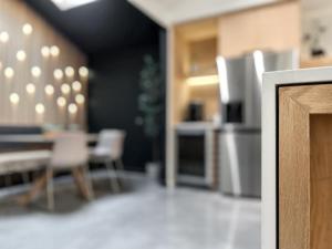 a room with a kitchen with a table and chairs at 1_OAK - experience custom design - 2 masters in Houston