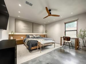 a bedroom with a bed and a ceiling fan at 1_OAK - experience custom design - 2 masters in Houston