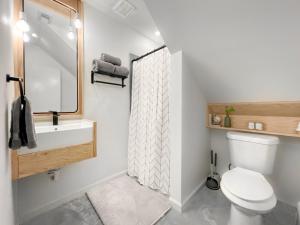 a bathroom with a toilet and a sink and a shower at 1_OAK - experience custom design - 2 masters in Houston +31 photos