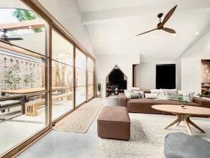 a living room with a couch and a ceiling fan at 1_OAK - experience custom design - 2 masters in Houston