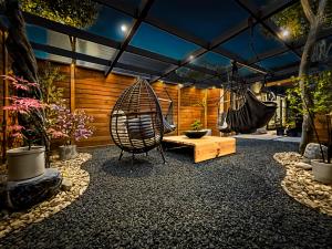 a patio with a hammock and a swing at 1_OAK - experience custom design - 2 masters in Houston