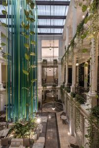 a lobby with a glass wall with plants at Piedra de Agua Hotel Boutique Mérida in Mérida