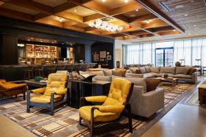 a bar with couches and chairs in a lobby at The Junto in Columbus