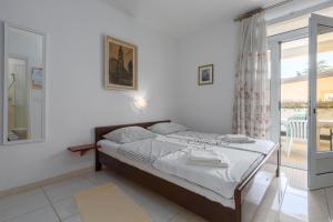 a bedroom with a bed and a sliding glass door at Apartments with a parking space Tar, Porec - 6948 in Tar