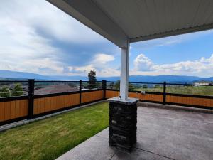 a porch with a view of the mountains at Yucca Tree-Licensed in Kelowna