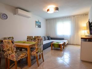 a living room with a couch and a table at Apartments by the sea Postira, Brac - 14822 in Postira
