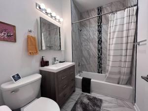 a bathroom with a toilet and a sink and a shower at Stay Rafa At 259 in Philadelphia +71 photos