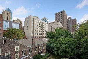 an old brick church in a city with tall buildings at Stay Rafa At 259 in Philadelphia