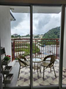a balcony with a table and chairs and a view at Camping Styles 2 Emerald Avenue Cameron Highlands 10Pax 821 Wifi in Brinchang