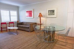 a living room with a glass table and chairs at Modern Boutique CBD 2BR 1st Floor Apt in Canberra