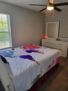 a bedroom with a bed and a ceiling fan at Serenity Apartment in Chesterfield