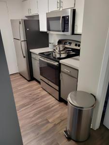 a kitchen with a stove and a microwave at Serenity Apartment in Chesterfield