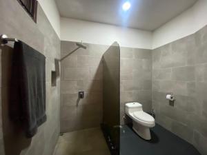 a bathroom with a toilet and a shower stall at Good Life Lodge in Sámara