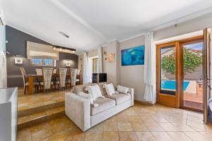 a living room with a couch and a dining room at The Quinta Bio Pool, Swimming Pool, 3 Bedroom ensuites Villa in Almancil