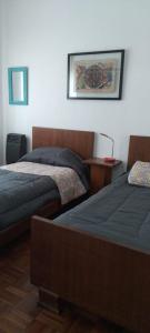 Una cama o camas en una habitación de Casa/ Villa General Belgrano