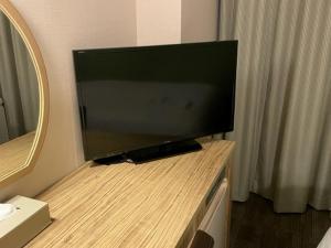 a flat screen tv sitting on a counter in a bathroom at Keikyu EX Hotel Takanawa in Tokyo