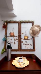 a table with two windows with writing on them at HOSTAL SEP7IMO ARTE in Bogotá