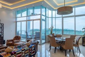 a living room with a couch and a table and chairs at 24o Penthouse Unique Design 2 Balconies Oceanview in ArraijÃ¡n