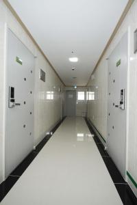 a hallway with white lockers and a white floor at BoA Travel House in Seoul