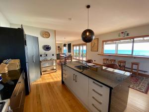 a kitchen with a counter top and a dining room at Wild Weka Eco Stay - Off-Grid 4WD RECOMMENDED in Waimarie