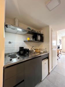 a kitchen with a sink and a stove top oven at Selbard Suite in Buenos Aires