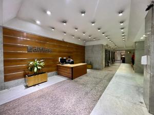a man sitting at a desk in an office lobby at Selbard Suite in Buenos Aires