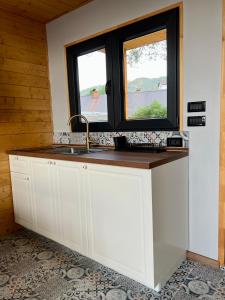 a kitchen with a sink and a window at Mount Log Cabin in Mavrovo