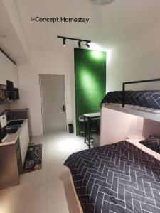 a bedroom with a bed and a green wall at I-Concept Homestay in Kuala Lumpur