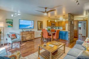 a living room with a couch and a table at Tropical & Serene Ground Floor in Kihei