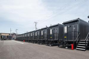 a row of black train cars parked in a parking lot at HOTEL R9 The Yard Sosa in Sosa