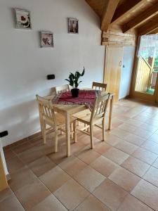 a dining room table and chairs with a potted plant on it at Ferienwohnung Kimmig in Bernbeuren