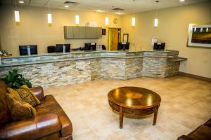 a lobby with a coffee table and a bar at Ocean Landings Resort in Cocoa Beach