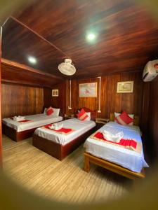 a room with two beds in a boat at Villa Thavisouk Legend - Luang Prabang in Luang Prabang