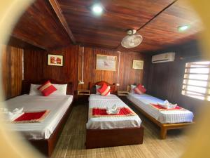 a room with two beds in a boat at Villa Thavisouk Legend - Luang Prabang in Luang Prabang