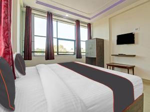 a bedroom with a large bed and a television at Super Collection O Fortune Inn in Pune