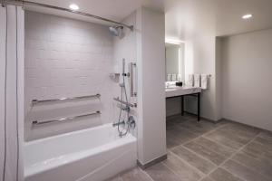 a bathroom with a bath tub and a sink at Portland Sheraton at Sable Oaks in South Portland