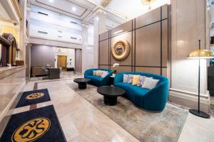 a lobby with two blue couches and a table at Sandman Signature Fort Worth Downtown Hotel in Fort Worth