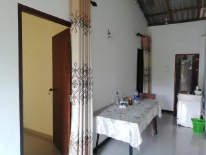 a dining room with a table with a table cloth at Galle Side HomeStay in Galle