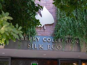 a sign for a ski lodge with plants on a building at Mulberry Collection Silk Eco in Hoi An +95 photos