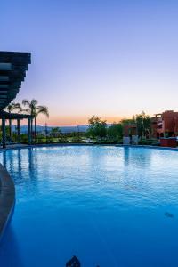 a large pool with blue water in a resort at Krystal Grand Residences & Villas San Miguel de Allende in San Miguel de Allende