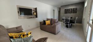 a living room with a couch and a dining room at Aquarela do Sertão in Piranhas