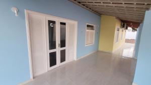 an empty room with white doors and a tile floor at Aquarela do Sertão in Piranhas +20 photos