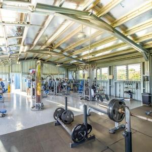 a gym with lots of equipment in a building at Kiahuna Plantation in Koloa